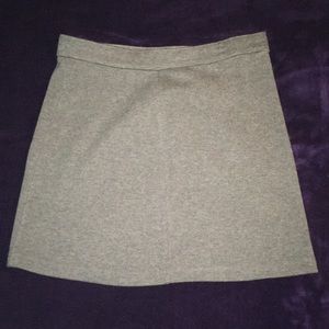A grey skirt with black tights